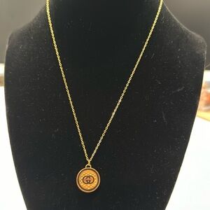 GG gold and black color necklace